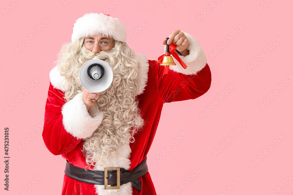 Santa Claus with megaphone and Christmas bell on pink background Santa Claus with megaphone and Christmas bell on pink background