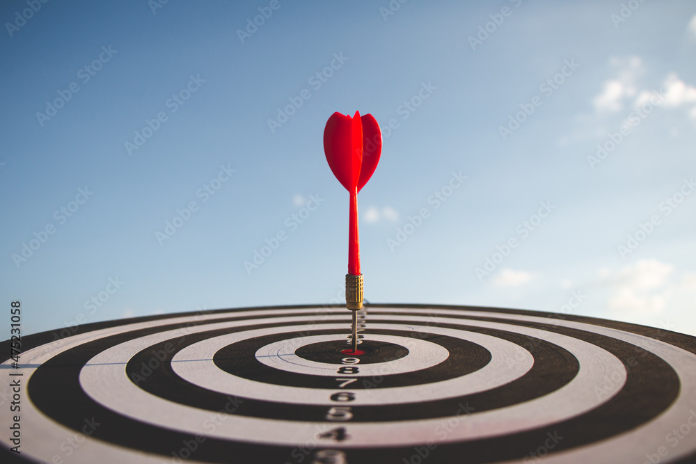 bullseye has red dart arrow throw hitting the center of a shooting for business targeting and winning goals business. bullseye has red dart arrow throw hitting the center of a shooting for business targeting and winning goals business.