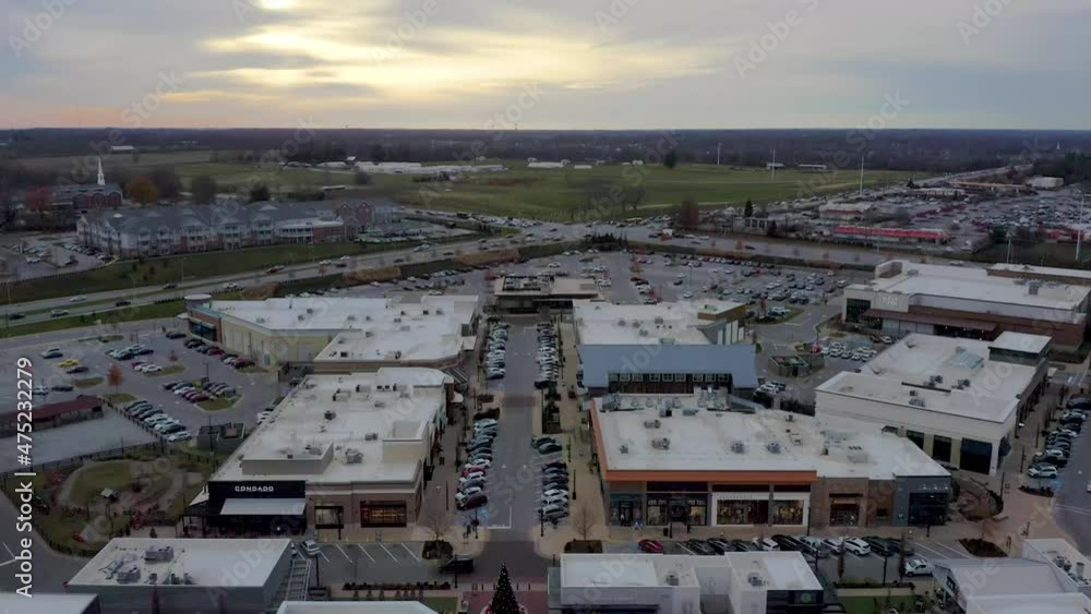 Dark aerial dolly shot of condominiums and a shopping center in Lexington Kentucky with a sunset in the background. 4k Dark aerial dolly shot of condominiums and a shopping center in Lexington Kentucky with a sunset in the background. 4k