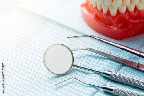 Some dental instruments laying on a blue dental napkin photo