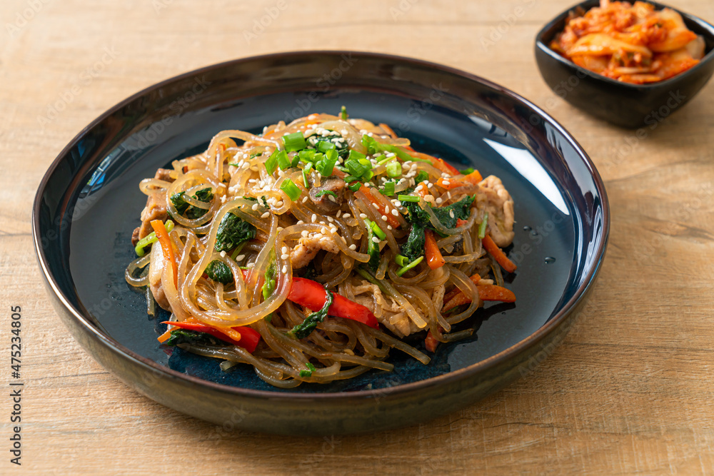 japchae or stir-fried Korean vermicelli noodles with vegetables and pork topped with white sesame japchae or stir-fried Korean vermicelli noodles with vegetables and pork topped with white sesame