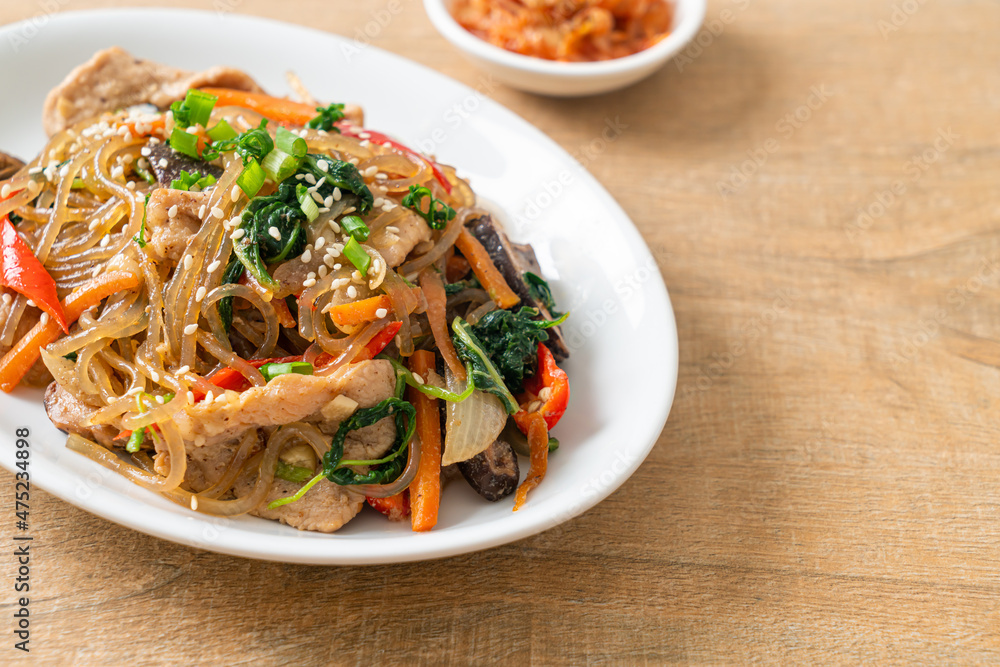 japchae or stir-fried Korean vermicelli noodles with vegetables and pork topped with white sesame japchae or stir-fried Korean vermicelli noodles with vegetables and pork topped with white sesame