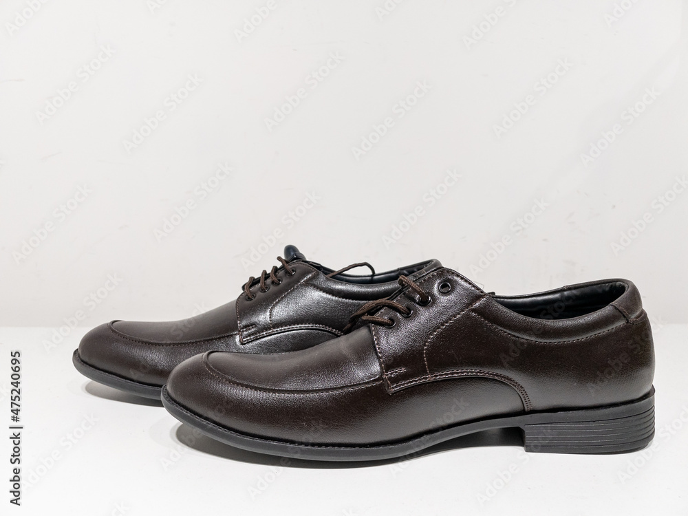 A pair of formal black shoes with laces displayed with white background
A pair of formal black shoes with laces displayed with white background