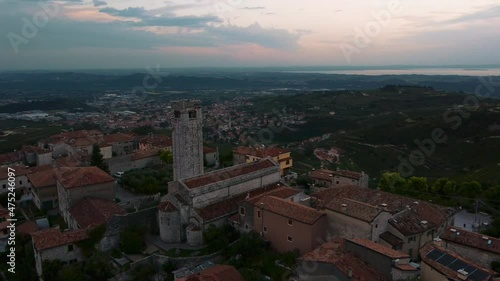 Wallpaper Mural Scenic old traditional Italian medieval castle village with a church tower on a hill in Valpolicella, Verona, Italy in autumn by sunset surrounded by fields. Cinematic aerial drone flying in 4K UHD. Torontodigital.ca