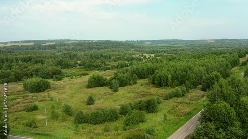 Aerial view of a country road through fields and woods
