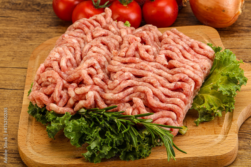 Raw pork minced meat over board Raw pork minced meat over board