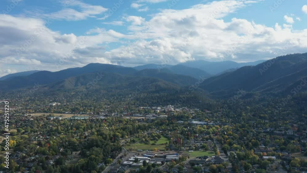 Beautiful view of the place Ashland in a slow motion cinematic shot of the natural background of the high mountains above the houses and trees on the land. Aerial view Beautiful view of the place Ashland in a slow motion cinematic shot of the natural background of the high mountains above the houses and trees on the land. Aerial view