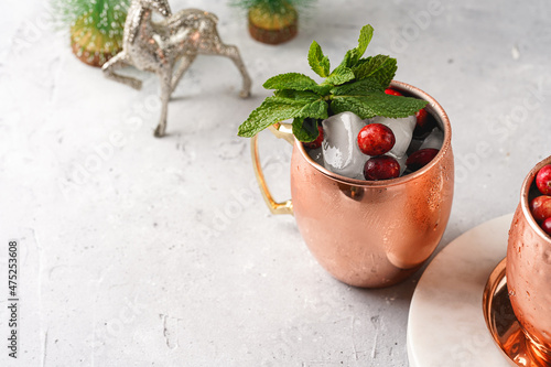 Photography Traditional american alcoholic beverage moscow mule in copper mugs with cranberr