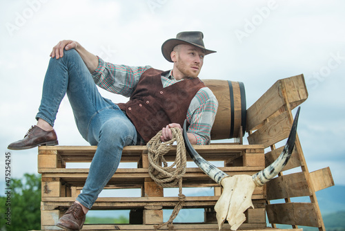 Cowboy wearing hat. Western life. Handsome bearded west farmer. Portrait of man cowboy or farmer. Western. Men retro fashion, vintage vogue, brutal male model.