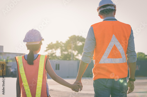 Father and daughter holding hand at Container cargo site. Business heir concept.  photo