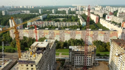 New high-rise apartment buildings under construction. Aerial photo at sunny evening