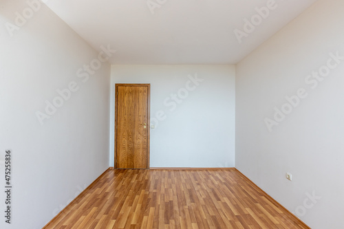 Empty bright living room. New home interior. Wooden floor.