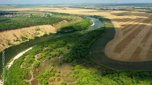 The tract Krivobor’ye the steep wooded sandy slopes of the Don river. A steep sandy cliff overgrown with forest on the Don River. The right bank is sandy, high and steep, and the left bank is flat and