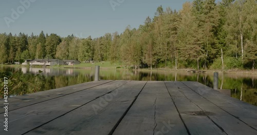 View From Wooden Bridge of Kypesjön Lake in Borås Sweden in Late Summer Afternoon - Low Wide Shot Tracking Forward and Truning Left photo