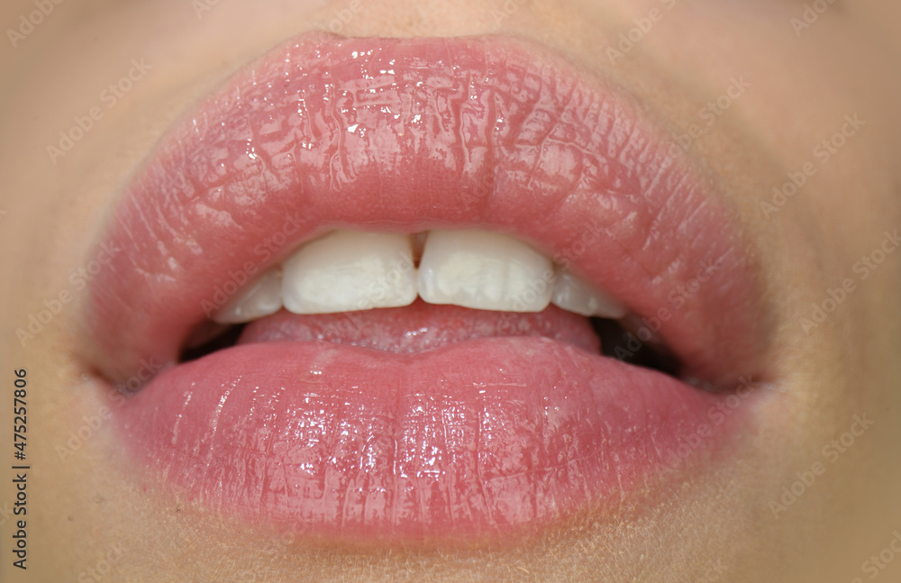 Fototapeta premium Beauty mouth expression concept. Close up of red lipstick on lips.