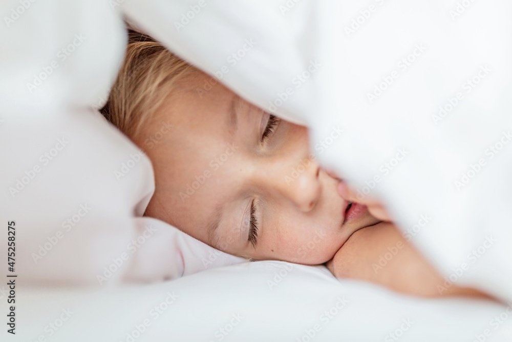 Beautiful caucasian little girl seven years old sleeping on the bed in bedroom at home. Beautiful caucasian little girl seven years old sleeping on the bed in bedroom at home.