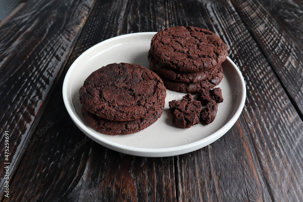 chocolate chip cookies on a plate with broken pieces. wooden rustic table. a copy of the space. chocolate chip cookies on a plate with broken pieces. wooden rustic table. a copy of the space.