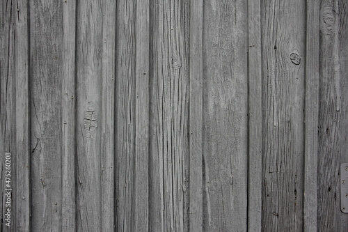 Old dry rural wooden wall with a many vertical gray boards vintage background texture