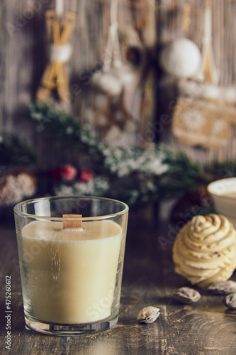 A fragrant handmade candle on the background of a New Year's decor.