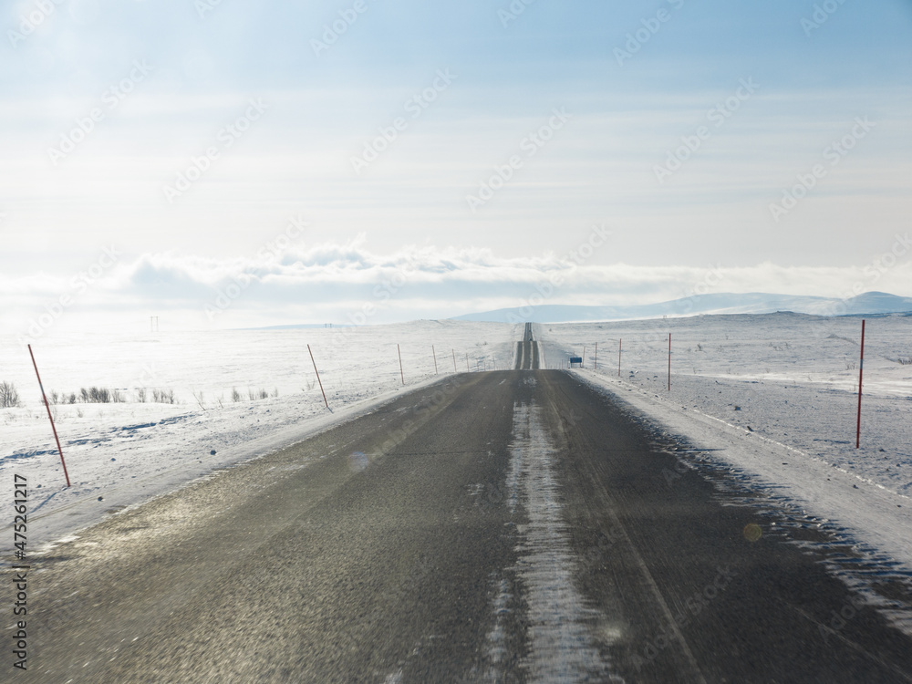 Road through the snow towards the horizon Road through the snow towards the horizon