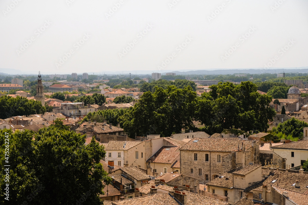 Tiled red roofs of the old town of Avignon, France. Hot summer afternoon. Top view. 