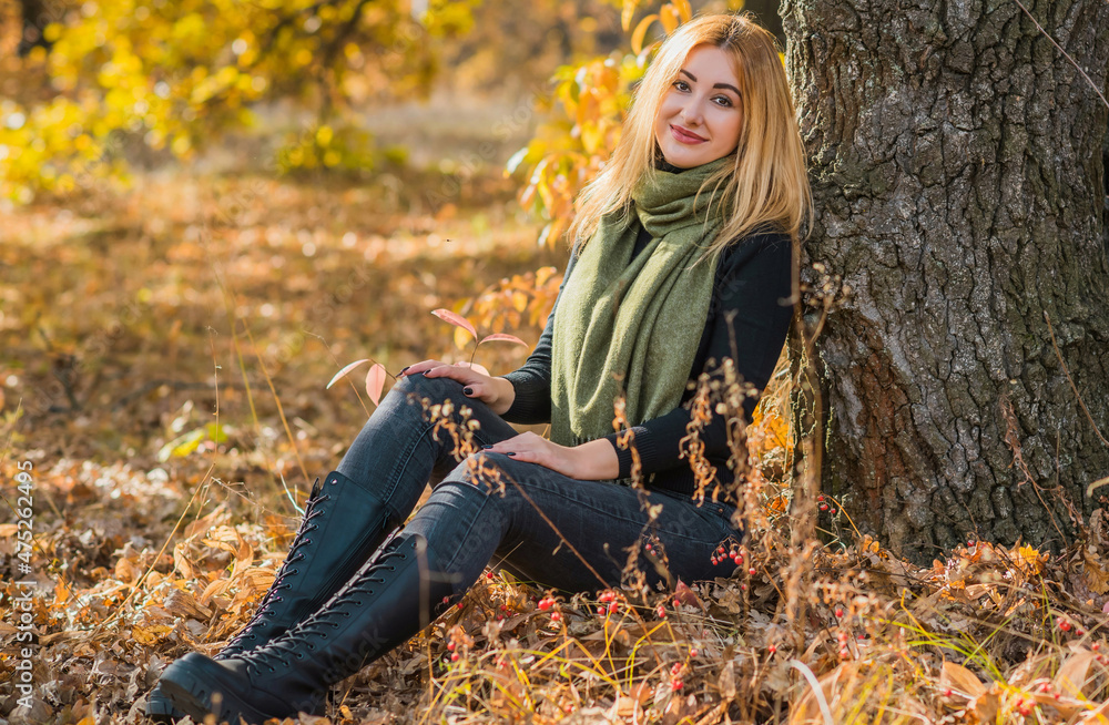 Fashionable details, women's outfits. Lady in black total look with green scarf Fashionable details, women's outfits. Lady in black total look with green scarf