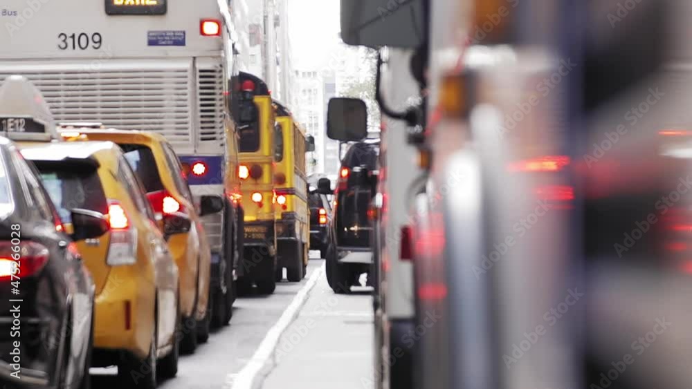 Daytime New York City Traffic With Buses, Cars, Taxis, And Pedestrian Loading Something Into Van. Daytime New York City Traffic With Buses, Cars, Taxis, And Pedestrian Loading Something Into Van.