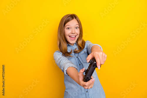 Photo of hooray little brown hairdo girl playstation wear denim shirt isolated on bright yellow color background