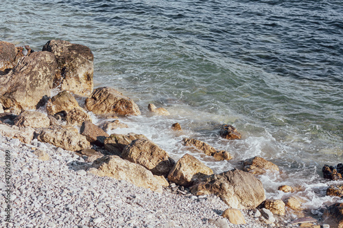 Rocky shore and calm sea waves 