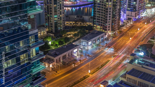 Aerial view on Dubai Marina skyscrapers and the most luxury yacht in harbor night timelapse, Dubai, United Arab Emirates