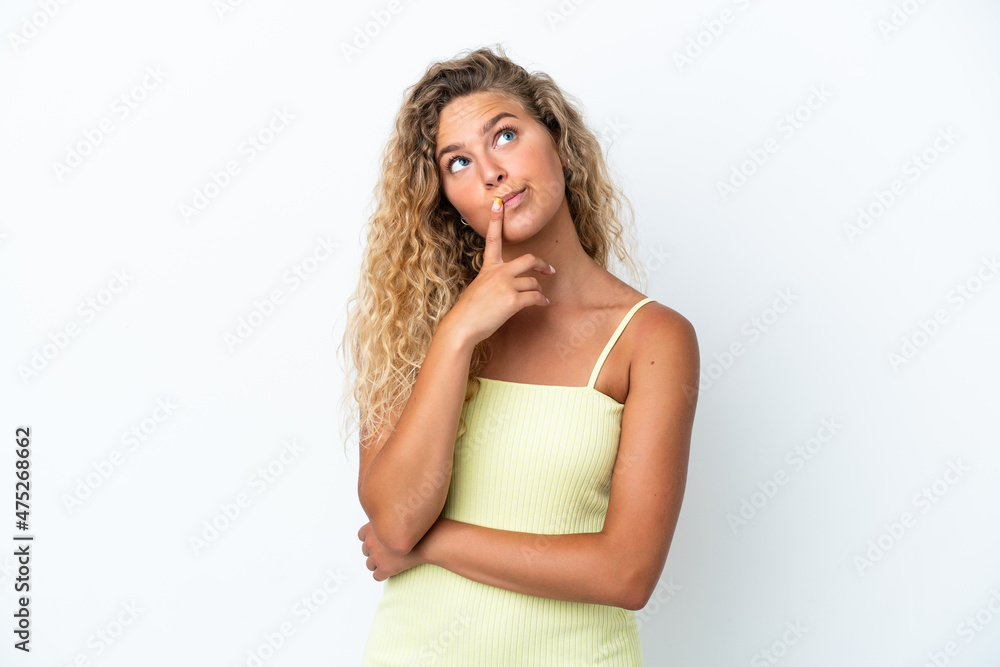 Girl with curly hair isolated on white background having doubts while looking up Girl with curly hair isolated on white background having doubts while looking up