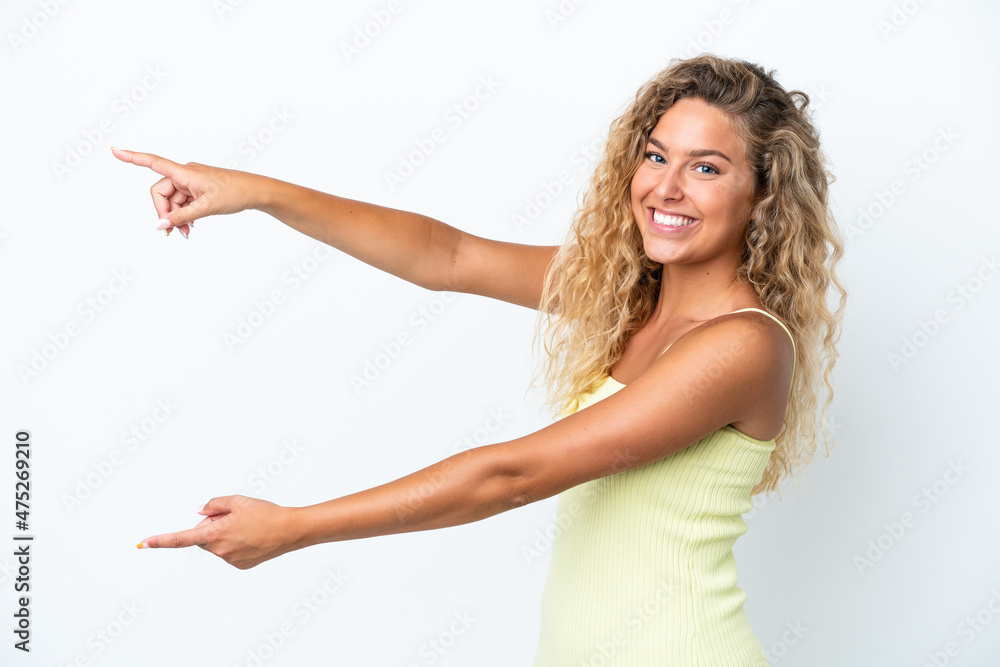 Girl with curly hair isolated on white background pointing finger to the side and presenting a product Girl with curly hair isolated on white background pointing finger to the side and presenting a product