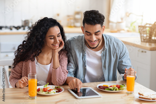 Young Middle Eastern Couple Shopping Online On Digital Tablet While Having Breakfast
