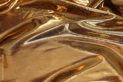 Gold foil background with ripples, textured golden, bronze, copper background