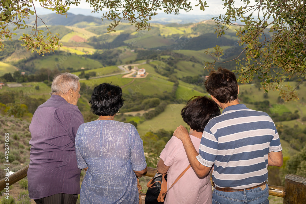 Grupo com dois casais de idosos conversando animadamente em um parque rodeado por árvores. o mais velho com mais de 80 anos de idade com cabelos totalmente brancos. Grupo com dois casais de idosos conversando animadamente em um parque rodeado por árvores. o mais velho com mais de 80 anos de idade com cabelos totalmente brancos.
