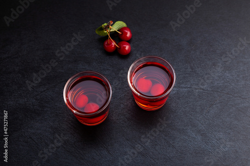 Ginjinha or Ginja - Tradition Portuguese liqueur made by infusing ginja berries (sour cherry, Prunus cerasus austera, Morello cherry) in alcohol (aguardente) and adding sugar photo