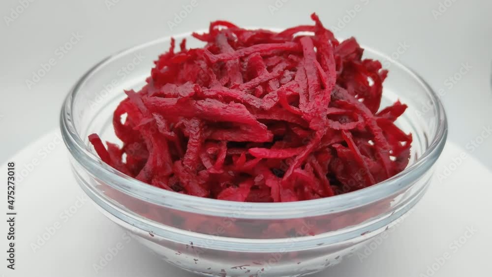 Chopped raw beets in a transparent plate. Close-up, rotation. Chopped raw beets in a transparent plate. Close-up, rotation.