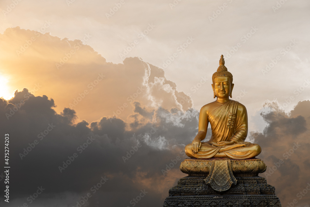 A peaceful superimposed and double exposure images of Golden Buddha statue from Wat Pathum Wanaram, Bangkok, Thailand and pink clouds. Buddha statue is posing “The attitude of subduing Mara A peaceful superimposed and double exposure images of Golden Buddha statue from Wat Pathum Wanaram, Bangkok, Thailand and pink clouds. Buddha statue is posing “The attitude of subduing Mara