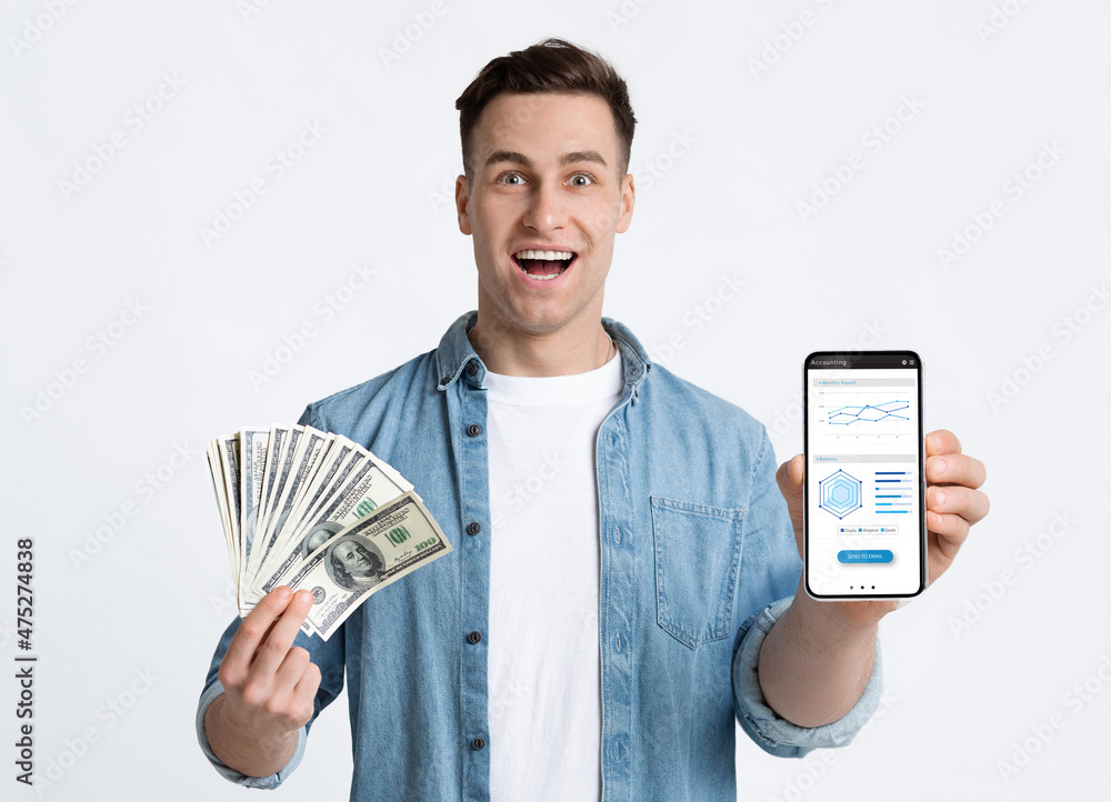 Emotional young man gambling online, showing prize Emotional young man gambling online, showing prize