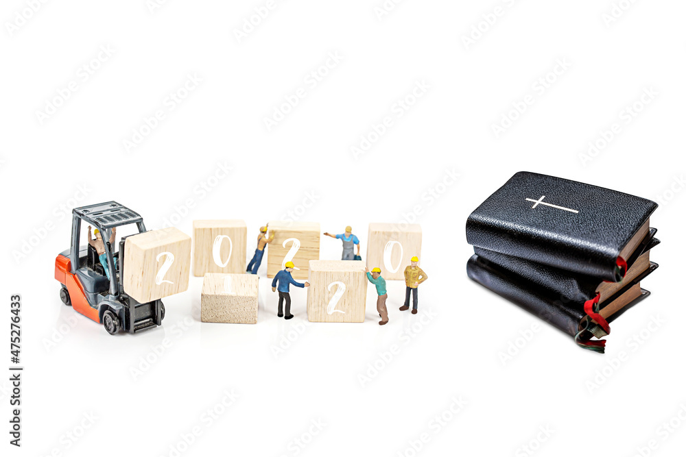 Fototapeta premium bible with miniature people isolate on white background.