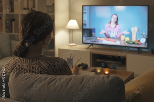 Woman watching a cooking show on TV