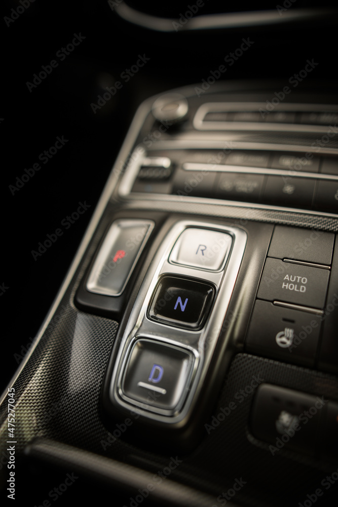 Obraz premium Automatic button gear shifter in a new car