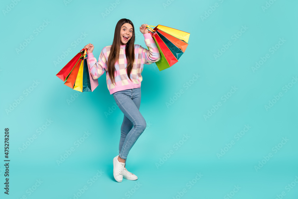 Photo of cute lucky school girl dressed prink pullover rising bags empty space isolated teal color background
