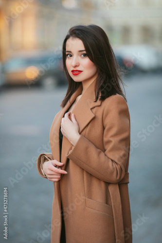 girl in coat in the street at sunrise