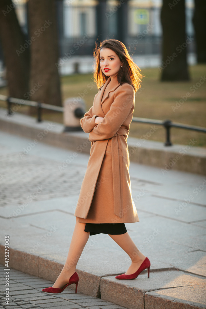 girl in coat in the street at sunrise girl in coat in the street at sunrise