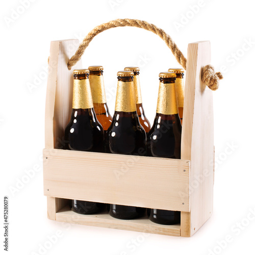 Beer bottles in a wooden beer crate isolated on white background.
