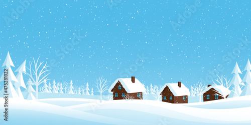 Winter landscape with snow covered houses and trees in the snow.