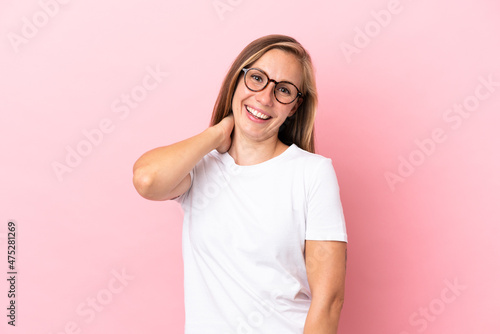 Young English woman isolated on pink background laughing