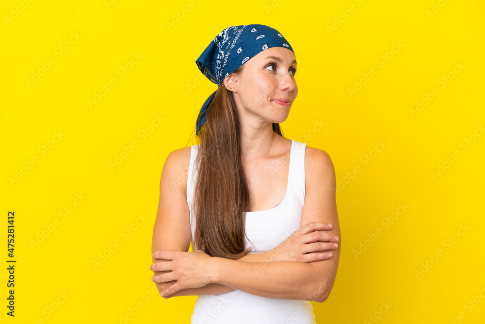 Young English woman isolated on yellow background looking to the side Young English woman isolated on yellow background looking to the side