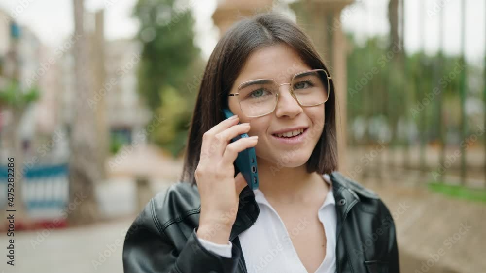 Young hispanic woman smiling confident talking on the smartphone at street Young hispanic woman smiling confident talking on the smartphone at street
